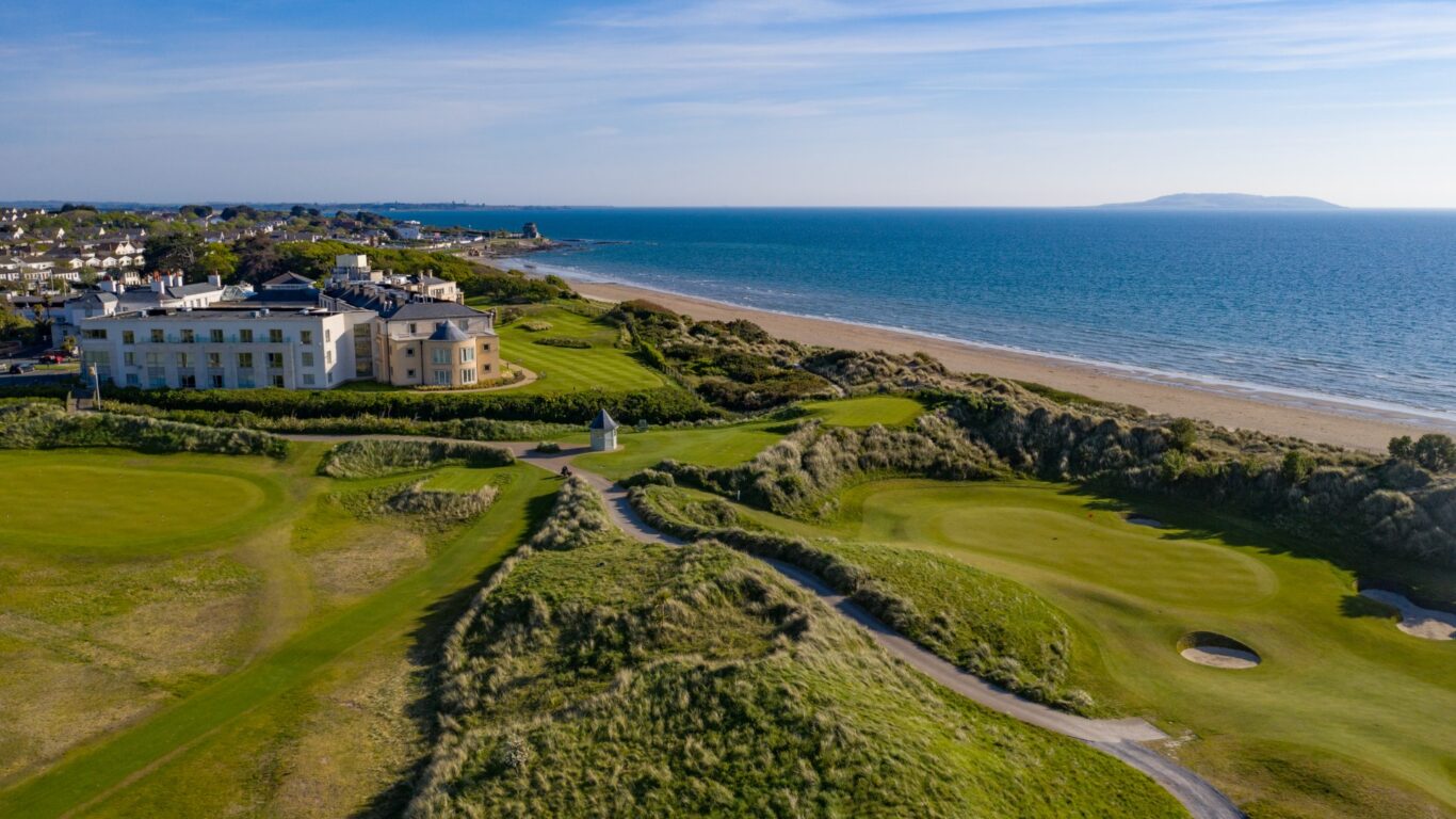 Elegant coastal hotel with lush golf course, stunning sea views, and beach access for a serene luxurious getaway.