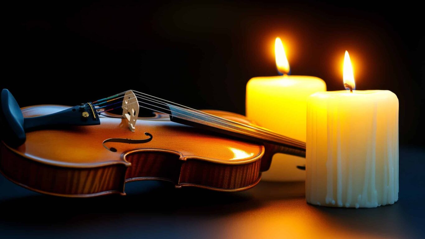 Close-up of violin with lots of candles and white highlights