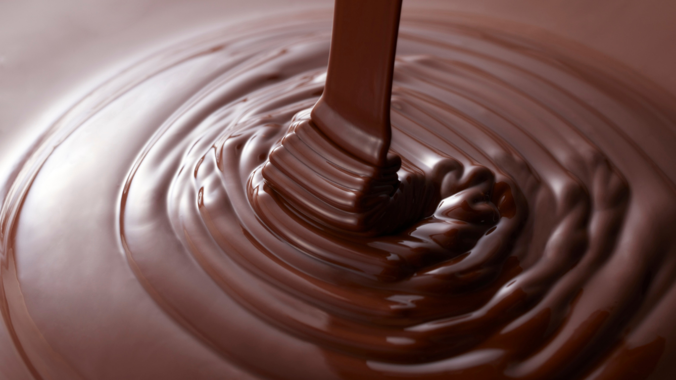 Smooth, rich chocolate being poured, capturing indulgence at our luxury hotel, featuring gourmet culinary delights.