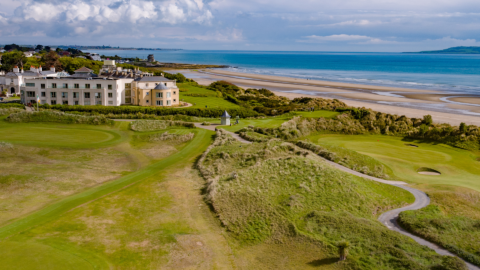 Coastal hotel with golf course overlooking a scenic beach and ocean views, perfect for relaxation and leisure activities.