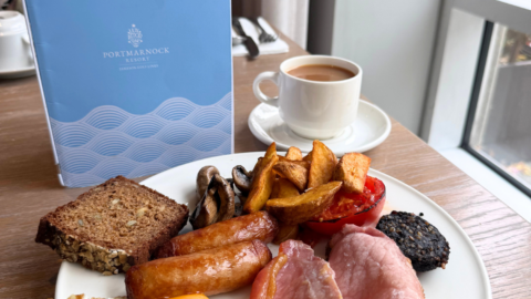Enjoy a full Irish breakfast with bacon, sausages, egg, soda bread, and coffee in a charming hotel dining room.