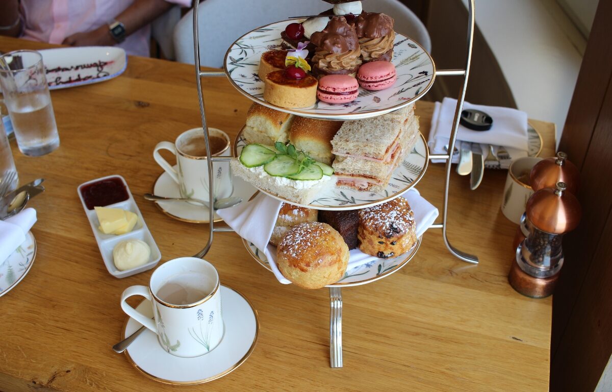 Indulge in elegant afternoon tea with scones, sandwiches, and pastries in a cosy hotel setting. Perfect for a relaxing retreat.